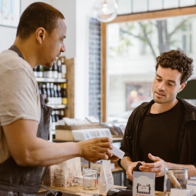 Cashier working with a customer at a small retail shop. 