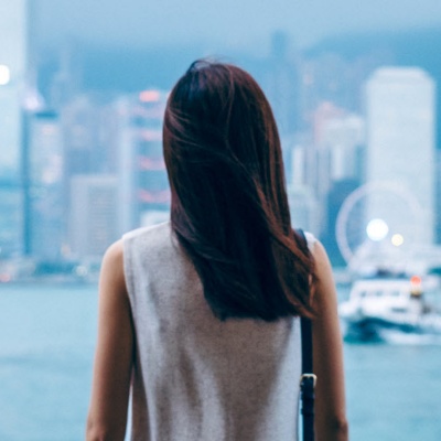 Person looking out at a cityscape.