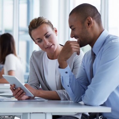 Two office workers collaborating in a conference room.