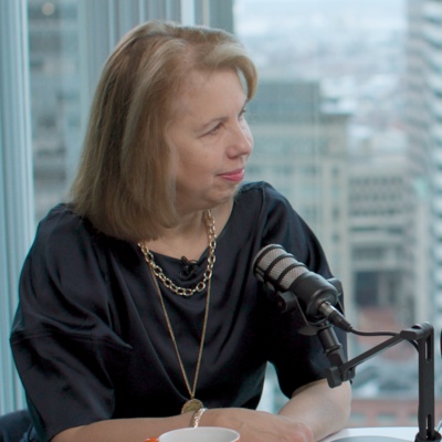 Kathy Pham and Nancy Gibbs sitting at a table together with podcast microphones. 