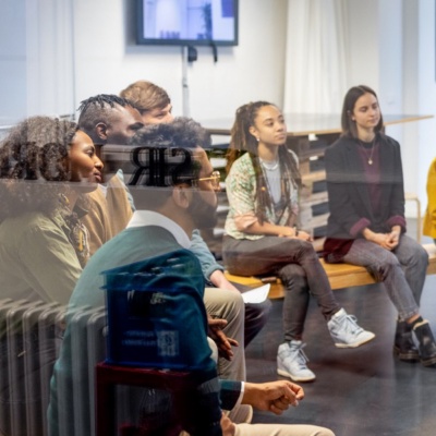 Business leader presenting to a group of colleagues in a casual office conference room