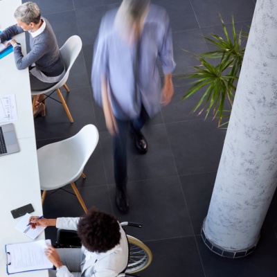 Aerial view of a group of professional colleagues working in a co-working or open concept workspace.