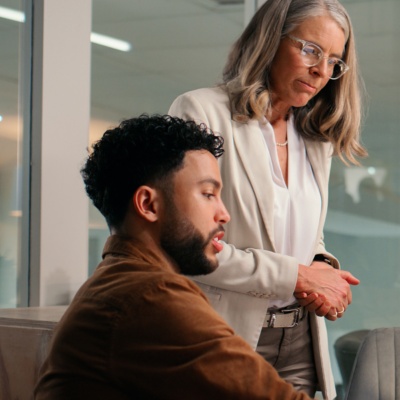Colleagues in office looking at computer