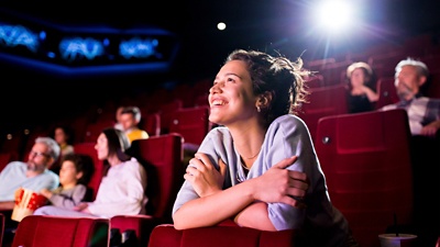 Image of a woman enjoying watching cinema