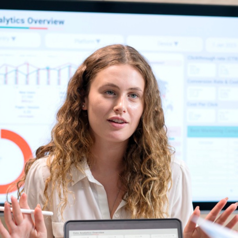 employee presenting to colleagues in conference room