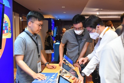 Attendees looking at board