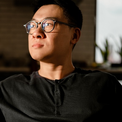 A man in an office looking thoughtfully into the middle distance