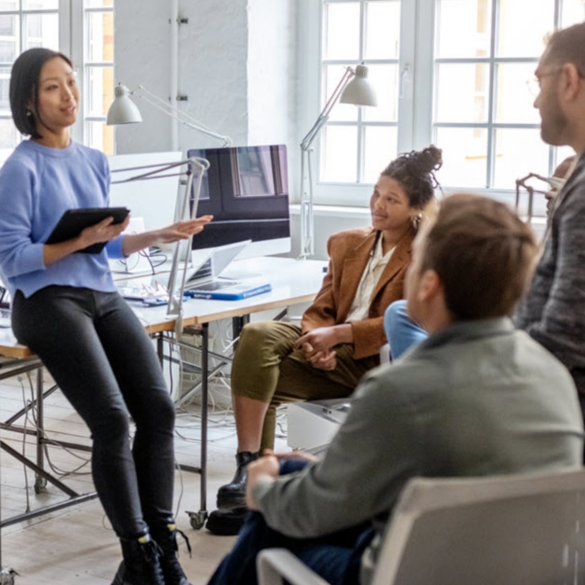 Employees talking in an open concept office space