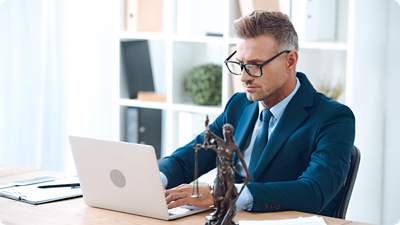 Man sitting at his desk working on his laptop