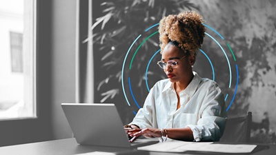 Woman focused at laptop.
