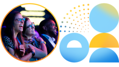 Event attendees smiling while watching a presentation