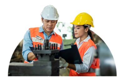 Two manufacturing employees looking over a plan.