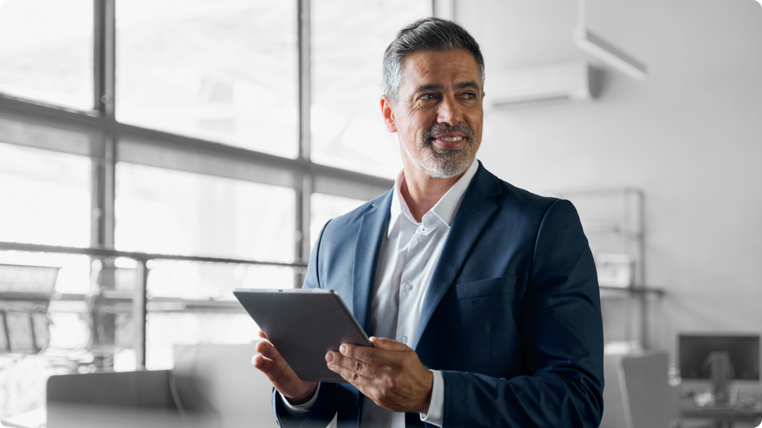 A man viewing a tablet at work at their medium sized business.