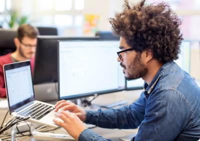 Man working in front of a laptop.
