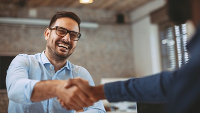 Image of man shaking hands. 