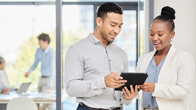 Man and woman looking at data on device