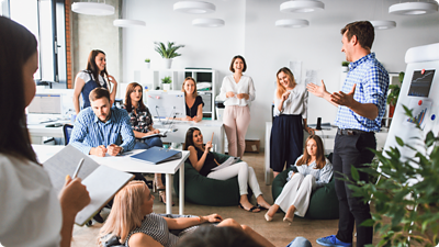 Image of people collaborating in a meeting room.