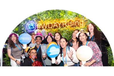 Group picture in front of Workday Rising neon sign.