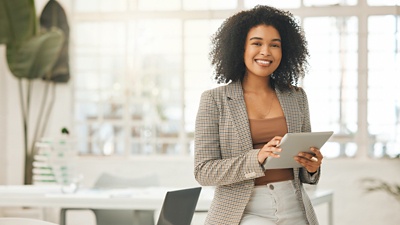 Woman smiling holding tablet