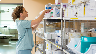Woman stocking medical supplies.
