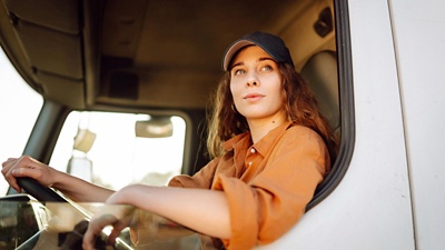 Woman truck driver in baseball cap