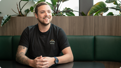 Man from Workday Analytics team sitting at a table.