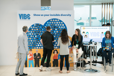 Attendees looking at board