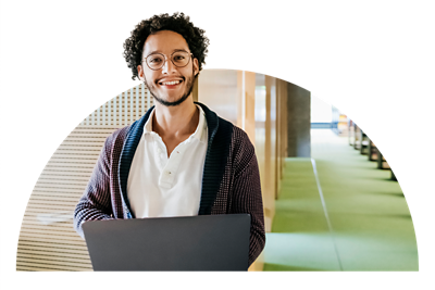 Person holding a laptop smiling.