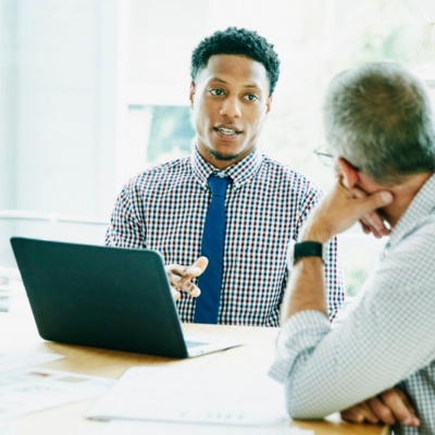 businessman leading meeting with clients