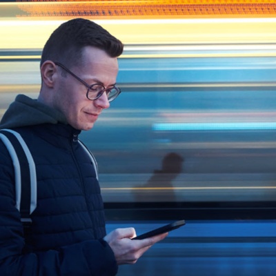 Person looking at their phone on a fast moving escalator 