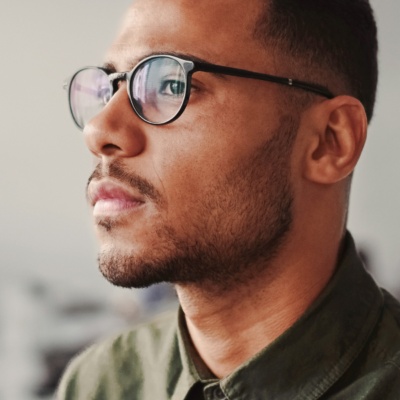 Man looking to side with glasses