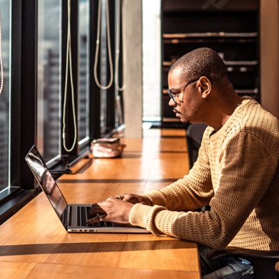 man on laptop in empty office