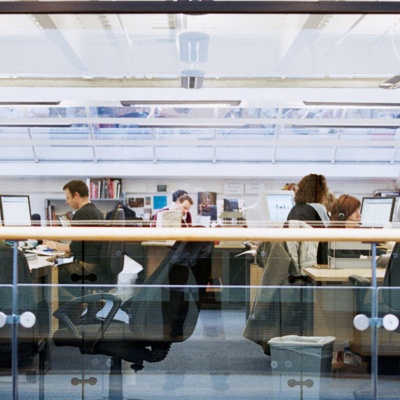 Employees working in an open floor plan office.