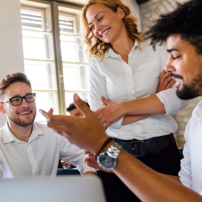 Group of office workers meeting in an open concept workplace.