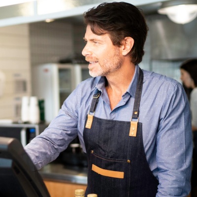 Employees working at the cash register of a quick service restaurant