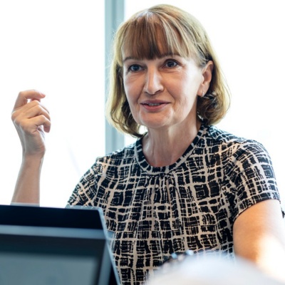 Employee holding tablet and speaking to another employee