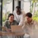 three people in office looking at computer