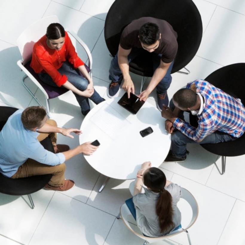aerial view of office workers collaborating around a table