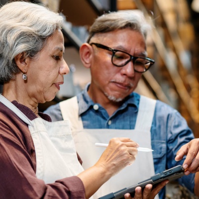 Two small business workers looking at a tablet.