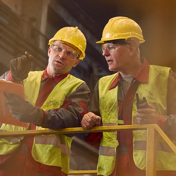 Two workers having a conversation in a warehouse