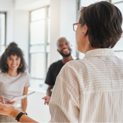 happy office workers listening to a coworker's presentation