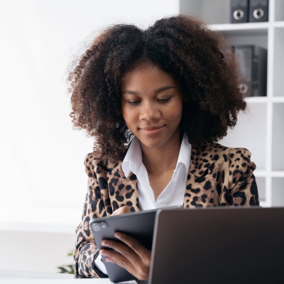 Office worker working on a tablet at a desk.