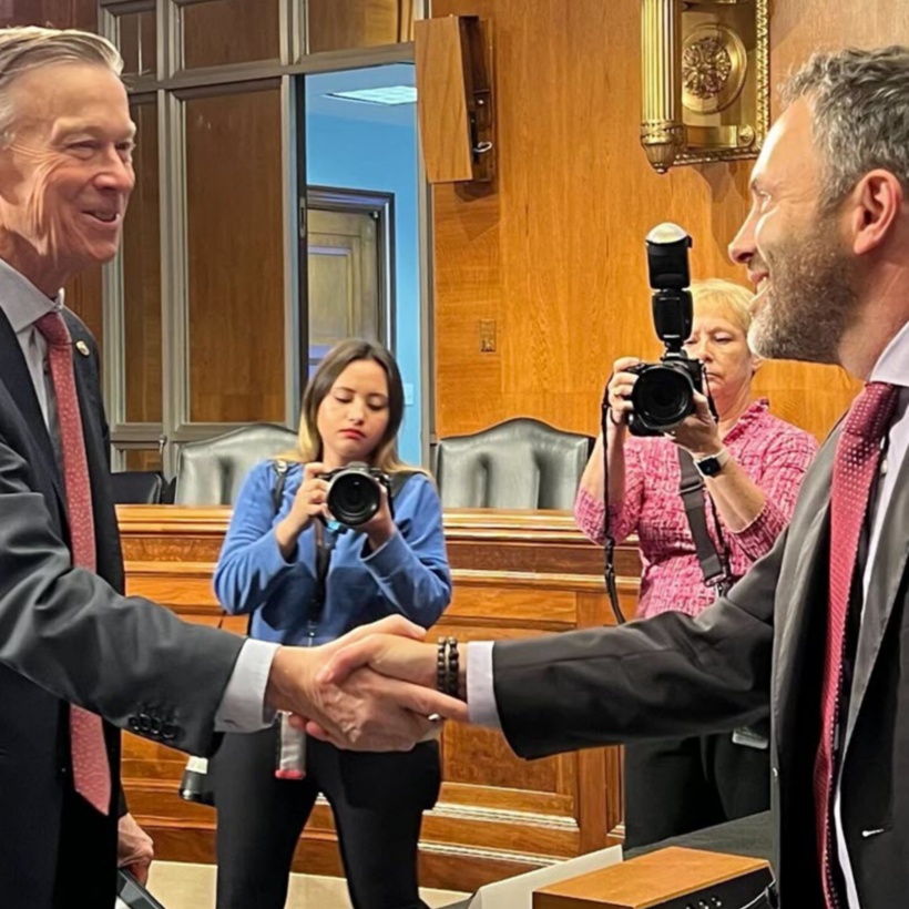 Josh Lannin shaking hands with a representative at the U.S. Congress.
